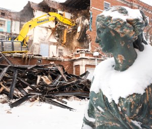 Statue faces building being demolished