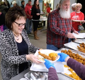 Roxanne Wieland receives her plate of baked and fried fish.